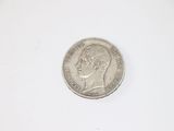 a close up of a coin on a white surface with a white background
