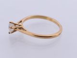 a gold engagement ring with a single stone diamond