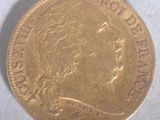 a close up of a gold coin on a white surface