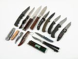 many different types of knives on a white surface