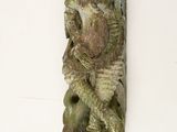 a small statue on the wall of a building