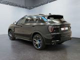the rear of a black bmw suv parked in a garage
