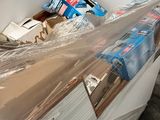 a white refrigerator with plastic wrap on top of it