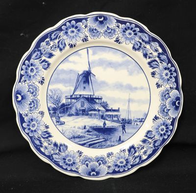 a blue and white plate with a windmill on it