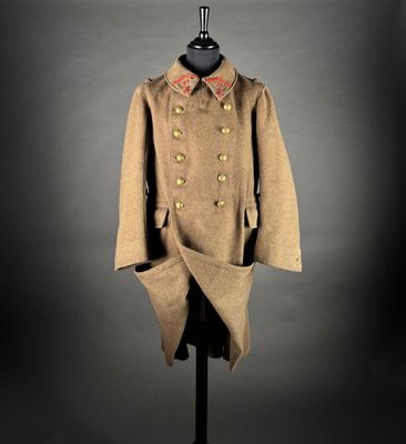 a coat on a mannequin stand with a black background