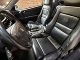 the interior of a car with black leather seats and a steering wheel