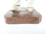 a figurine of a man standing on top of a box