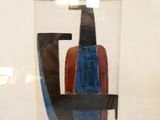 a glass with a picture of a man sitting in a chair