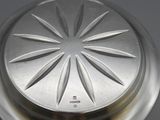 a silver plate with a flower design on it