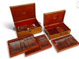 four pieces of silverware in a case on the table