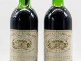 two bottles of wine sitting next to each other on a white surface