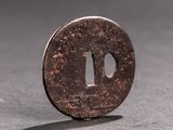 a close up of a coin with a hole in the middle