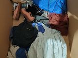 a cardboard box filled with clothes and a blue shirt
