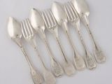 six silver spoons and a fork on a white surface