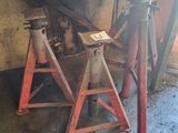 a pair of red jack stands in a garage