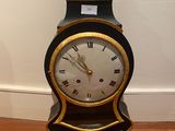 a black and gold clock with roman numerals on it