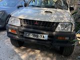 a dirty car that is parked on the side of the road