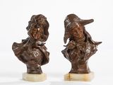 pair of bronze busts of a man and a woman on marble bases