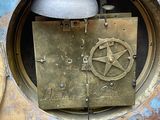 a clock that has a pentagram on the side of it