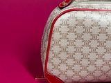 an image of a white and red purse on a pink background