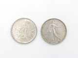 a close up of two silver coins on a white surface