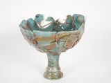 a blue bowl with a bird on it on a white surface
