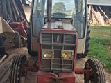 a tractor that is parked in the dirt