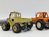 two toy trucks that are sitting next to each other