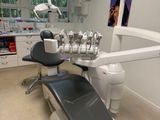 a dentist ' s chair in the corner of the room