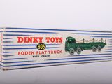 a box of dinky toys with a green truck on it