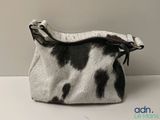 an image of a purse with a cow print on it