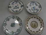 three plates with blue and green designs on them on a table
