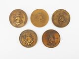 four different types of coins are shown on a white surface
