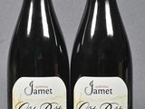 two bottles of wine sitting next to each other on a table