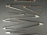 several different types of surgical instruments are arranged on a table