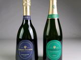 two bottles of champagne sitting next to each other on a table