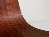 a close up of a wooden chair on a white surface
