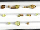 many different colored stones in a black box on a table