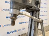 a machine that is sitting on a stand in front of a wall