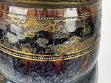 a close up of a vase with a lid on a white background