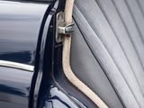 the door of a blue car with a white stripe on it