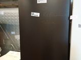 an image of a refrigerator in a warehouse with stickers on the door