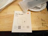 packaging for a pet dryer sitting on a table next to a bag of dog food
