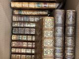 many old books in a cardboard box together