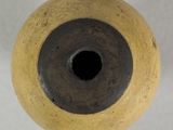a close up of a vase with a hole in it