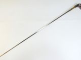 a long metal stick with a handle on a white surface