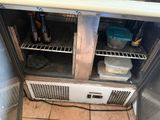 a small refrigerator with a lot of food inside of it