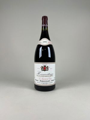 the bottle of wine is sitting on the table ready to be eaten
