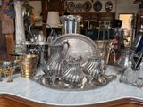 a table with a lot of silver items on it