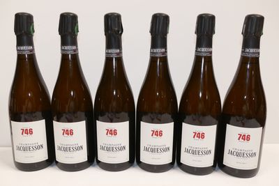 six bottles of wine are lined up on a table